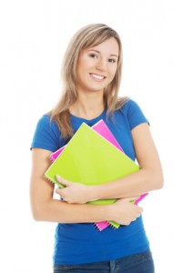 Young happy and satisfied student holding workbook.